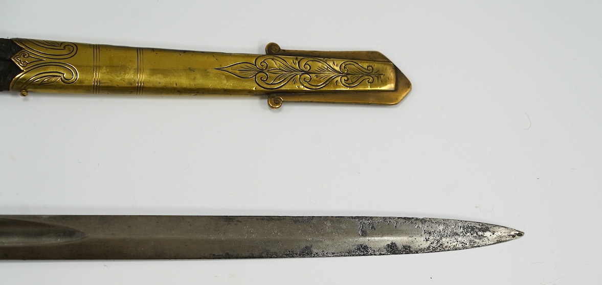 A Victorian warrant officer's sword by Westcott and Sons, regulation brass hilt, black fish skin covered grip, in its brass mounted leather scabbard, blade 79.5cm. Condition - well worn